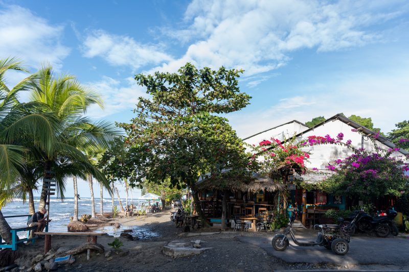 Tropical beach scene with ocean and lush green trees. Puerto Viejo de Talamanca, Costa Rica, 2024, © Dirk Heurich, dirksn.com