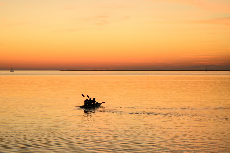 Kayaking pink plush toy on calm lake Copyright Dirk Heurich dirksn.com