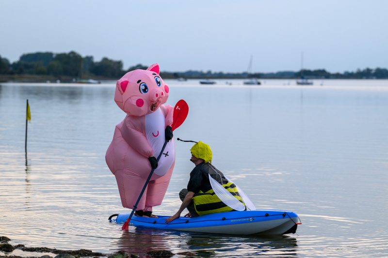 Kayaking pink plush toy on calm lake Copyright Dirk Heurich dirksn.com