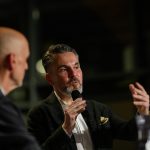 Man speaking into microphone at an event © Dirk Heurich dirksn.com