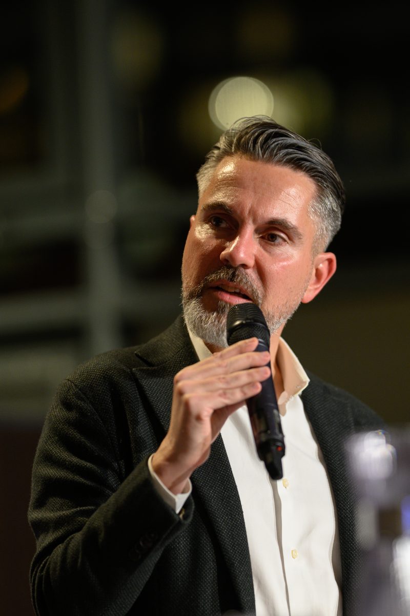 Man speaking into microphone at an event © Dirk Heurich dirksn.com