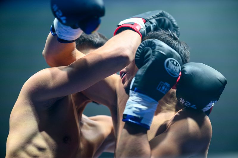 Boxers mid-fight in intense boxing match © Dirk Heurich dirksn.com