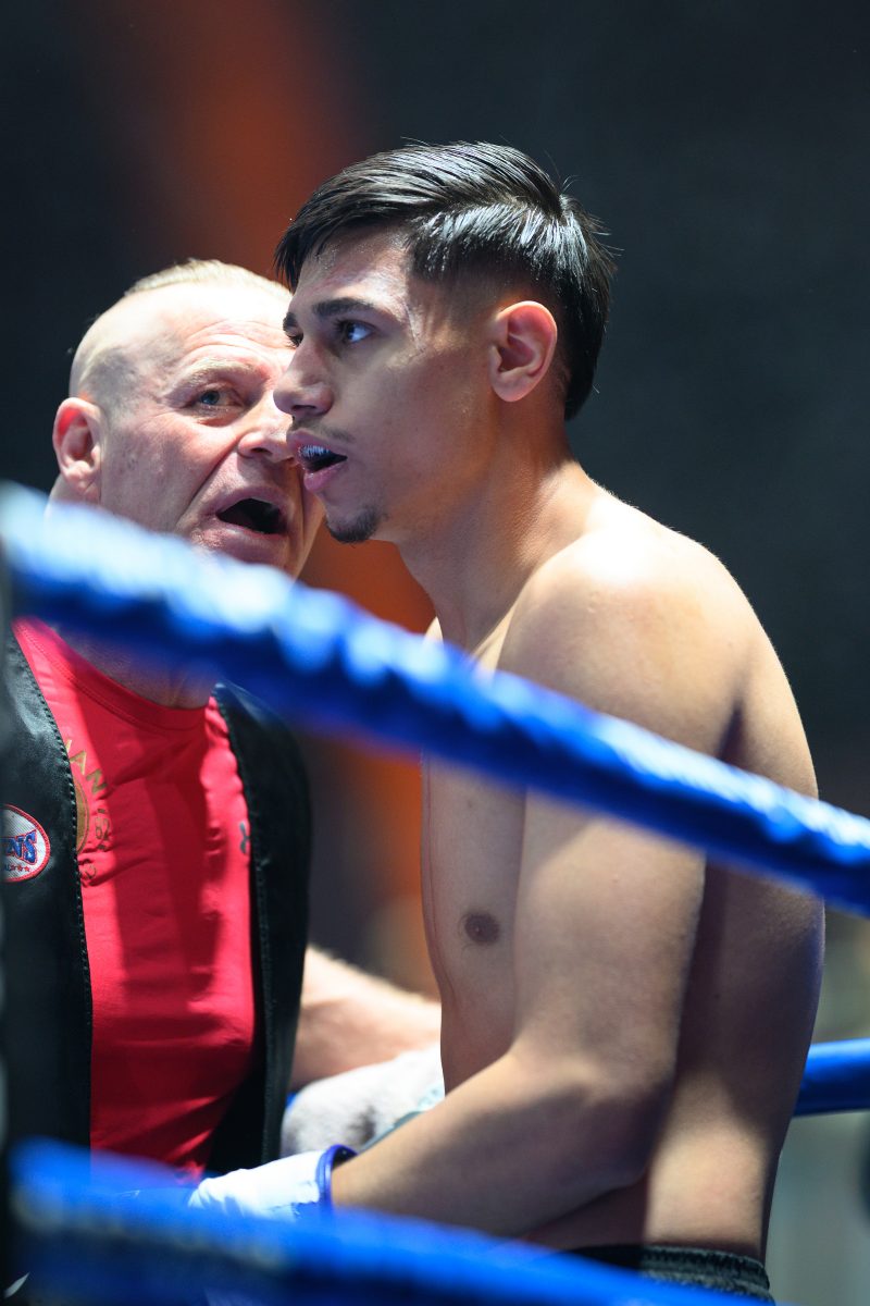 Boxers mid-fight in intense boxing match © Dirk Heurich dirksn.com