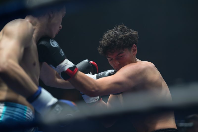 Boxers mid-fight in intense boxing match © Dirk Heurich dirksn.com