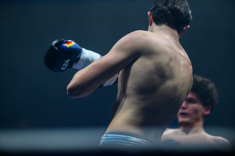Boxers mid-fight in intense boxing match © Dirk Heurich dirksn.com