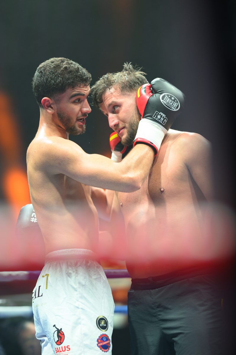 Boxers mid-fight in intense boxing match © Dirk Heurich dirksn.com