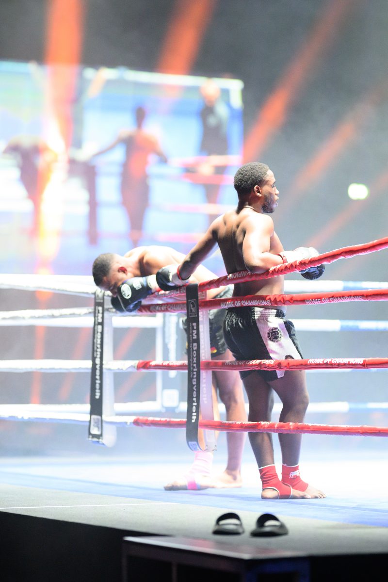 Boxers mid-fight in intense boxing match © Dirk Heurich dirksn.com