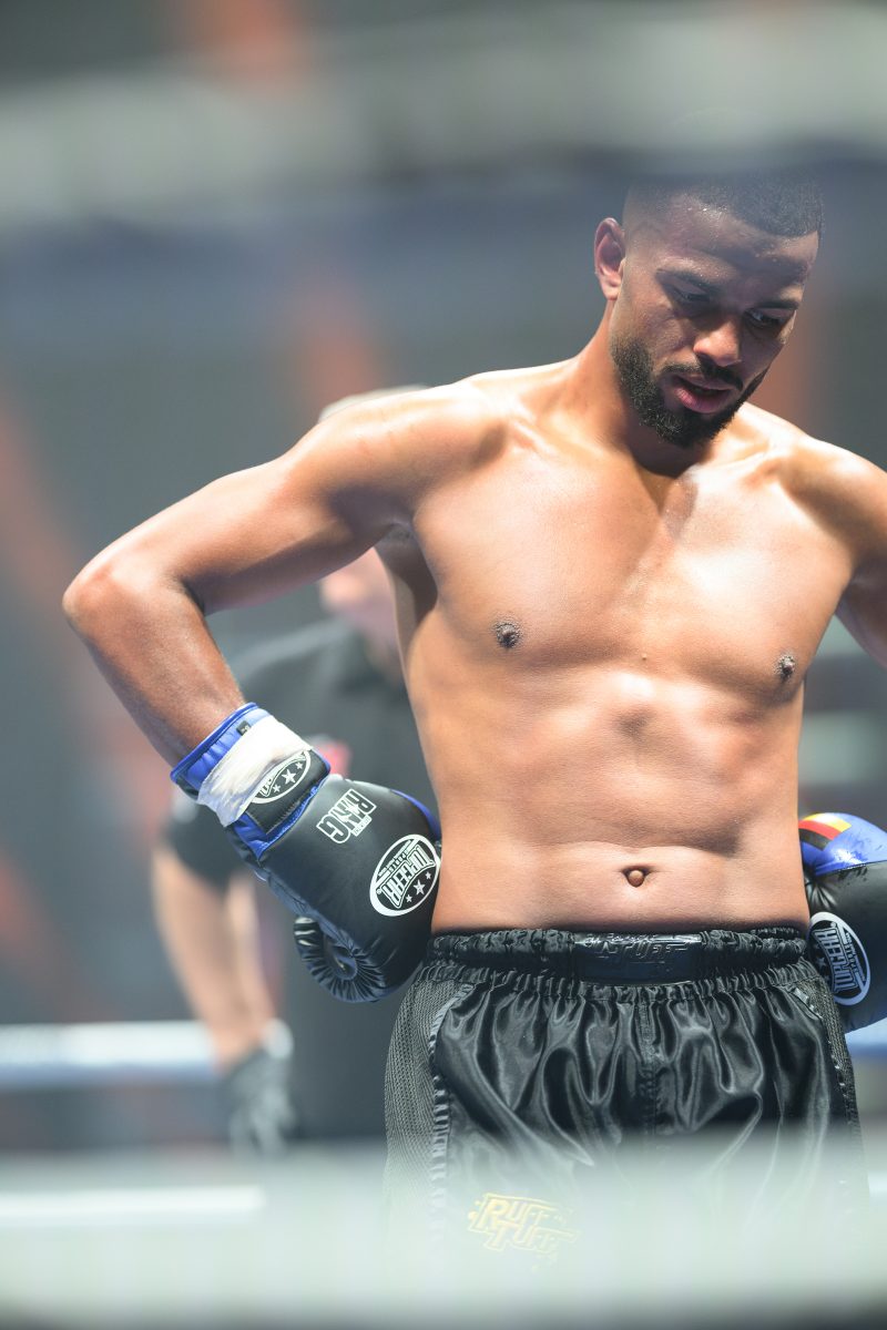 Boxers mid-fight in intense boxing match © Dirk Heurich dirksn.com