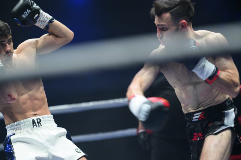 Boxers mid-fight in intense boxing match © Dirk Heurich dirksn.com