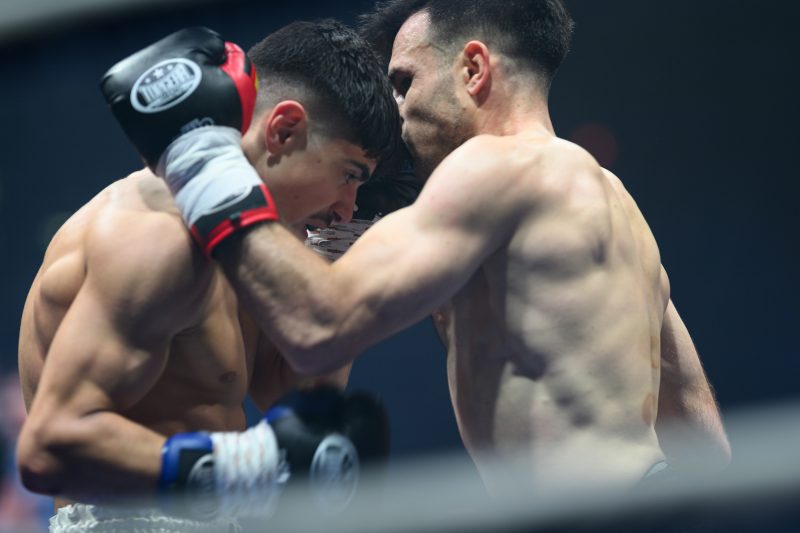 Boxers mid-fight in intense boxing match © Dirk Heurich dirksn.com
