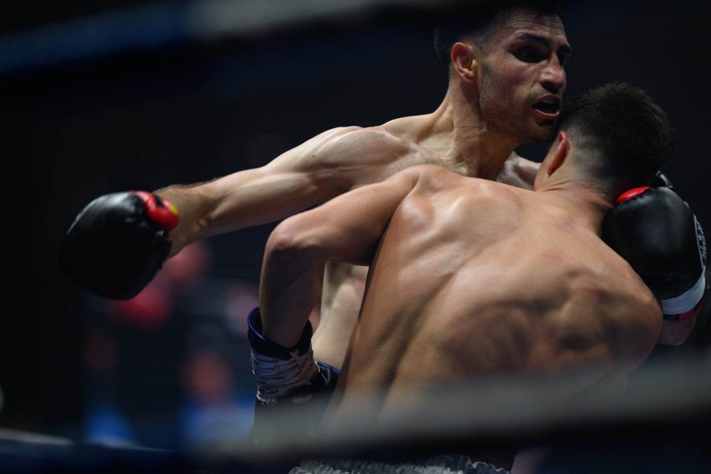 Boxers mid-fight in intense boxing match © Dirk Heurich dirksn.com