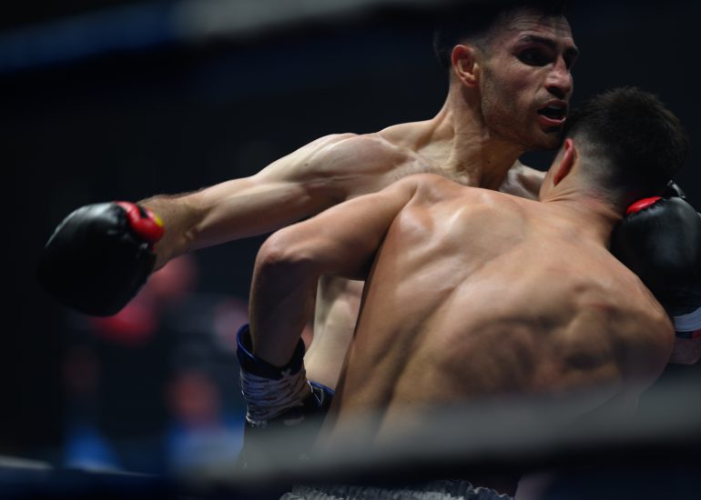 Boxers mid-fight in intense boxing match © Dirk Heurich dirksn.com