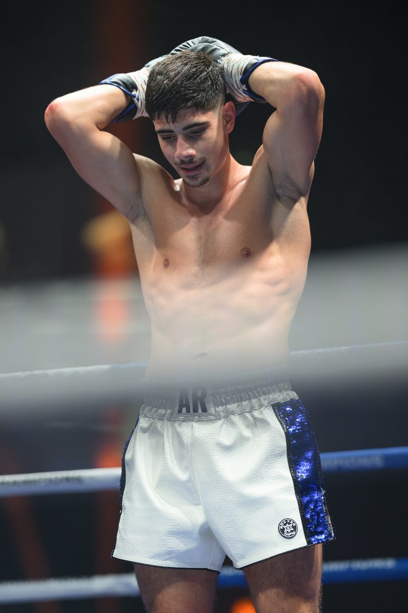 Boxers mid-fight in intense boxing match © Dirk Heurich dirksn.com