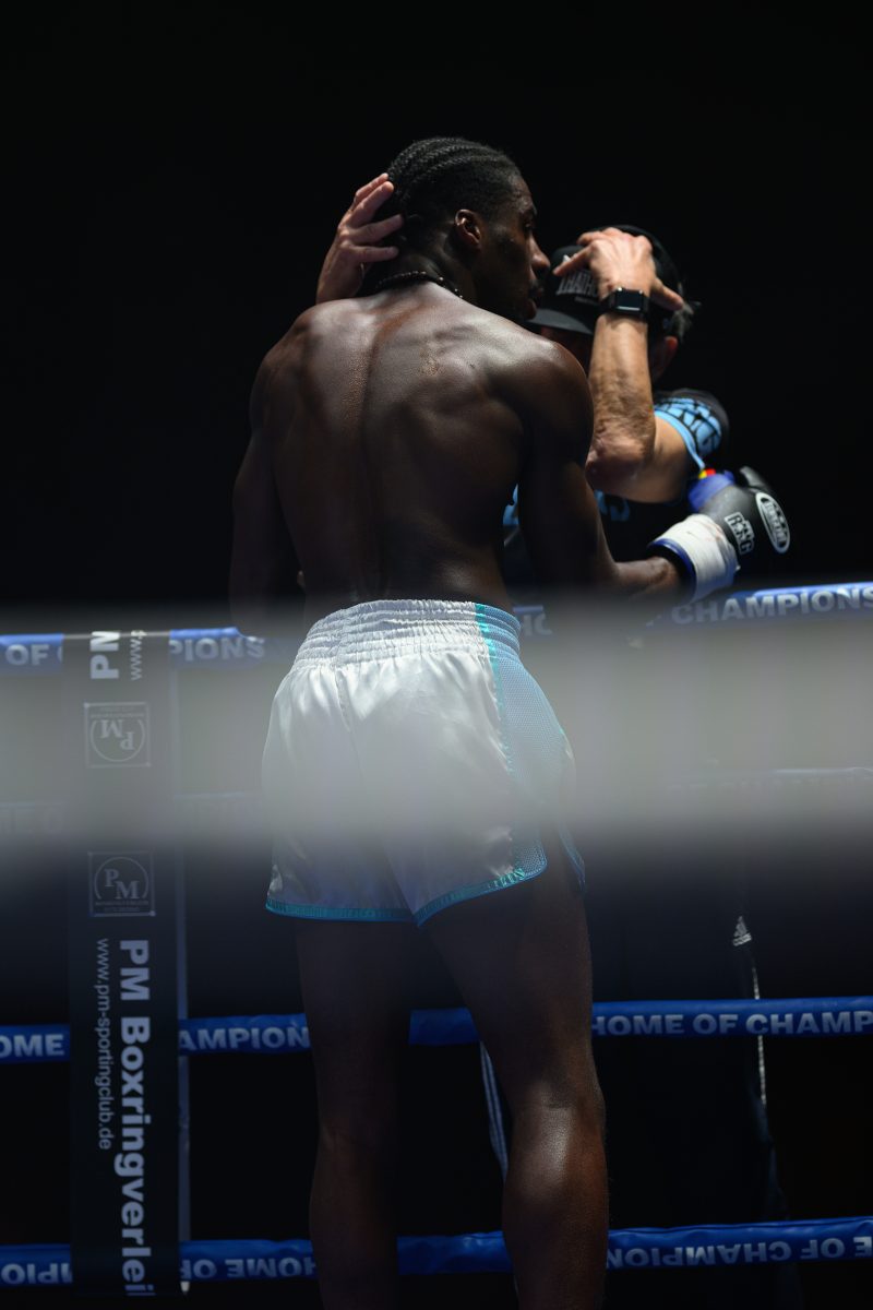 Boxers mid-fight in intense boxing match © Dirk Heurich dirksn.com